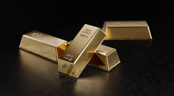 istock Gold Bars Sitting on One Hundred American Dollar Banknotes 1219649294
