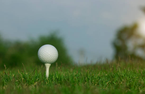 istock golf ball on tee in a beautiful golf course 1219649369
