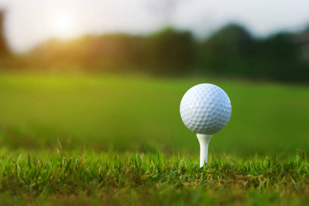 istock golf ball on tee in a beautiful golf course 1219649377