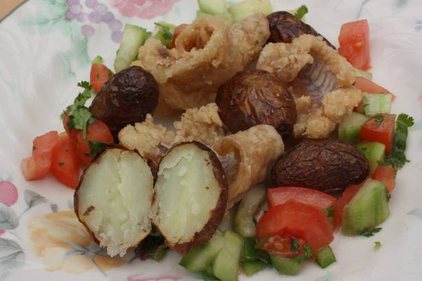 istock Dry cod fritters served with mixed salad and roasted potatoes 1219660790