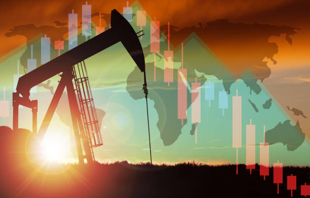 istock Sunset Over Pumpjack Silhouette With Stock Chart and World Map Background 1219662827