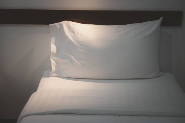 istock White bedding and pillow in hotel room. Comfort and bedding concept 1219663558