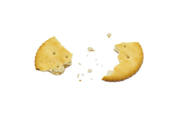 istock Biscuits cracker with crumbs and circle design. Isolated on white background. 1219664506