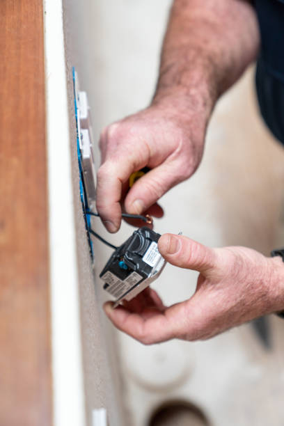 istock Electrician working in home installing dimmer switched in wall 1219670805