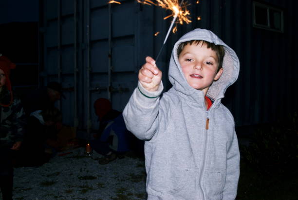 istock Young Child Holds a Sparkler on Fireworks Night 1219671758