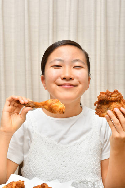 istock Japanese girl enjoys having fried chicken 1219675225