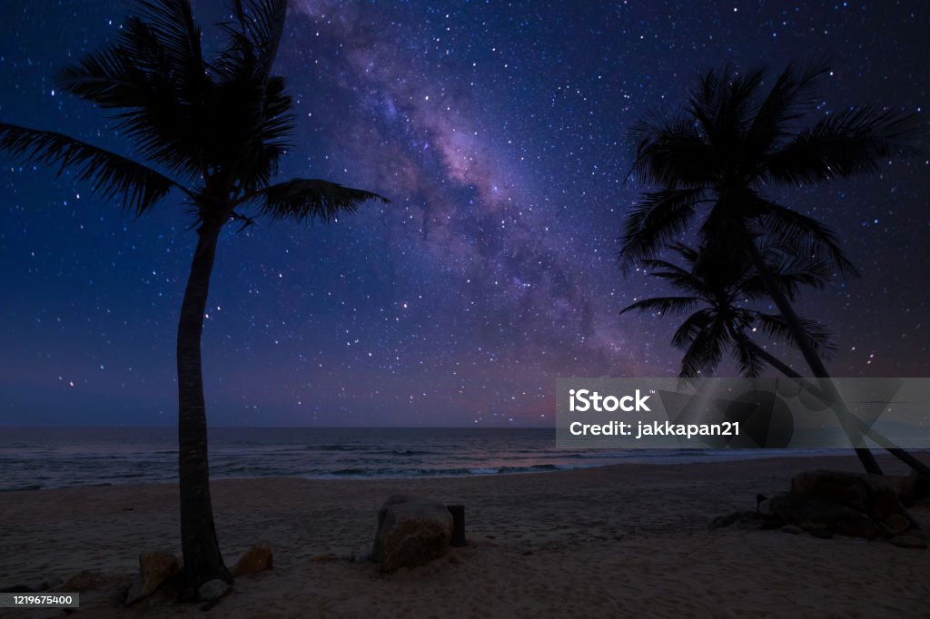 romantic beach and milky way with star. Beautiful nature fantasy - romantic beach and milky way with star. Retro style with vintage color tone. Summer season, honeymoon in night skies background concept. Beach Stock Photo