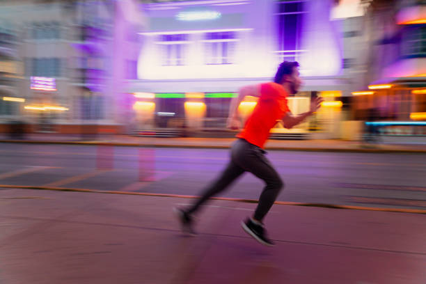 istock Cuban Millennial running in Miami Beach 1219676866
