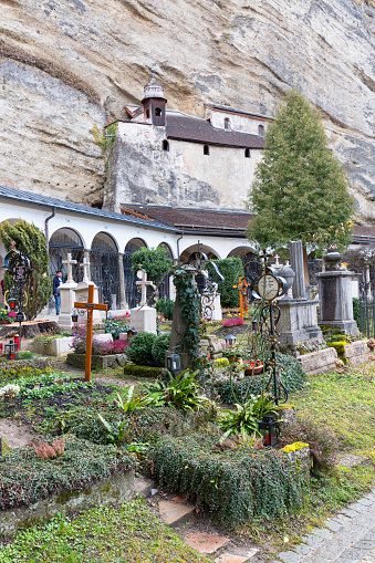 Salzburg, Austria - March 10, 2019 : St. Peter's Cemetery known as Petersfriedhof. It is the oldest cemetery in Salzburg, located at the foot of the Festungsberg with Hohensalzburg Castle