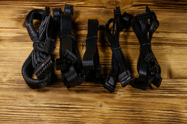 istock Set of cables for computer PSU on a wooden desk 1219677870
