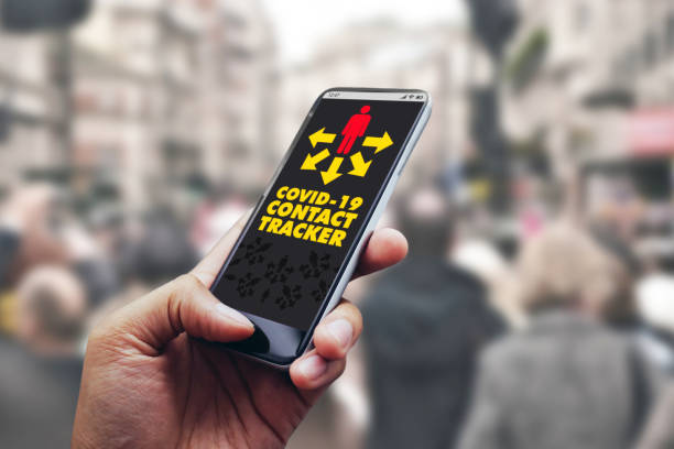 istock Covid-19 app on smartphone software in crowd of people with bluetooth notification 1219679203