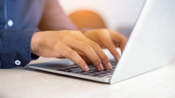 istock A woman's hand using and touching on laptop touchpad stock photo 1219679298