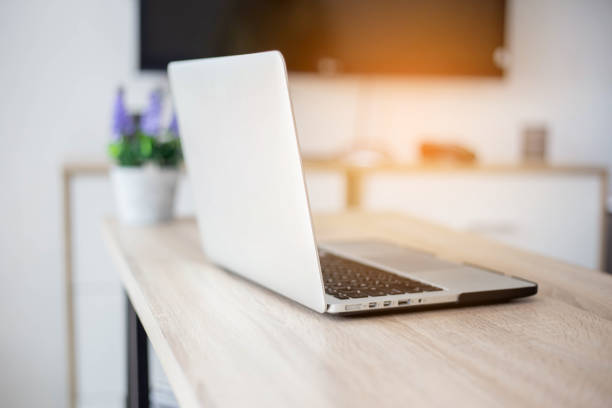Brand new notebook with with display on table. notebook computers stock photo