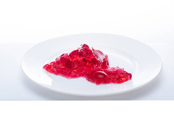 istock Red shapeless jelly on a white plate. Red jelly on a white background. Isolate Jelly. 1219680059