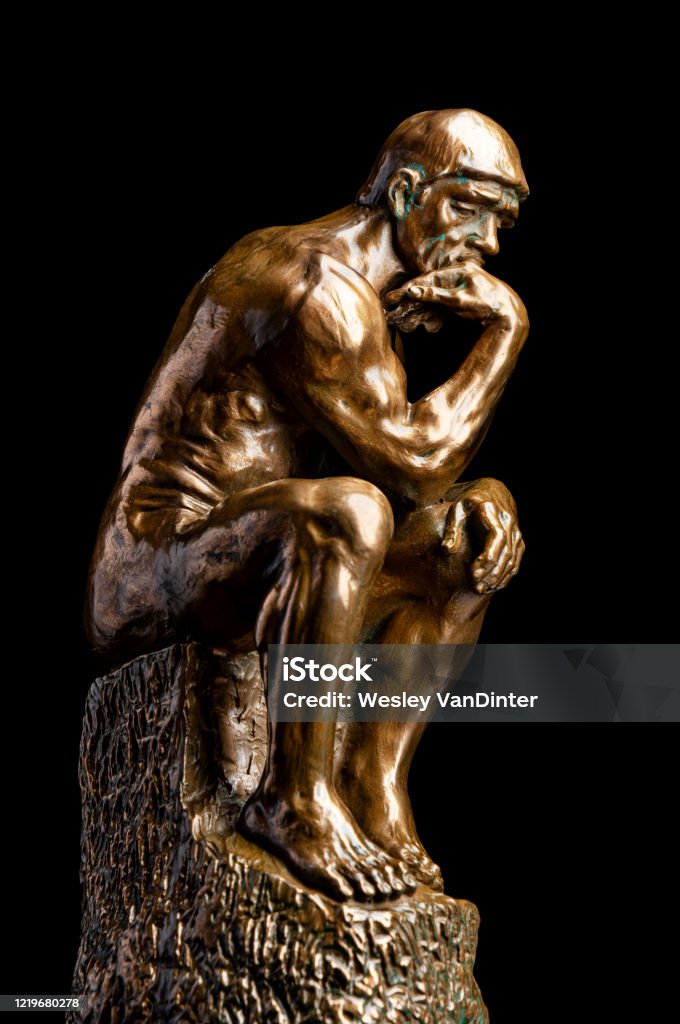 Thinker on Black A bronze replica statue of Rodin's Thinker on black Auguste Rodin Stock Photo