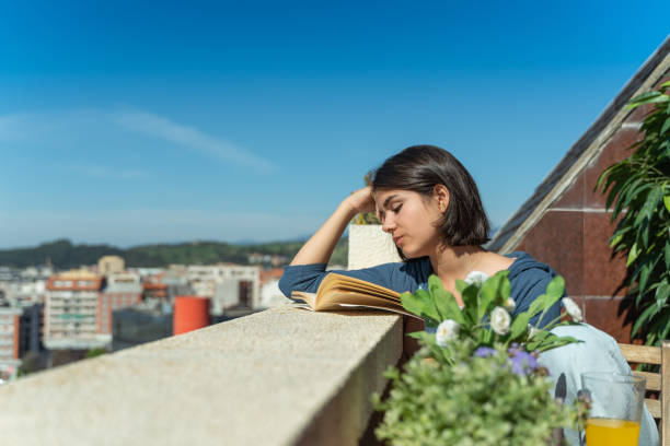 istock Woman reading a book during lockdown 1219681142