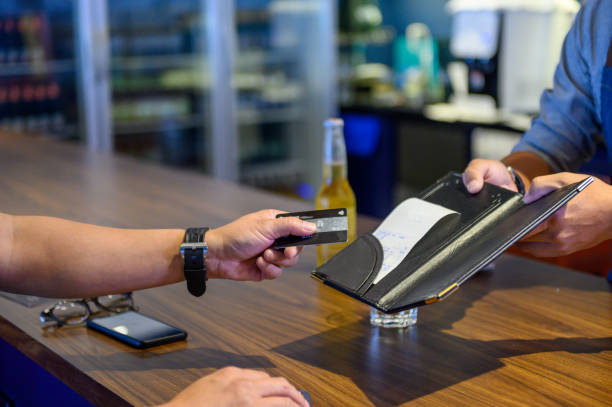 istock Waiter taking credit card payment from customer 1219681781