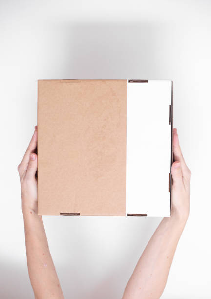 istock A parcel cardboard box in a delivery man hands on a white background. Delivery service concept. 1219684781