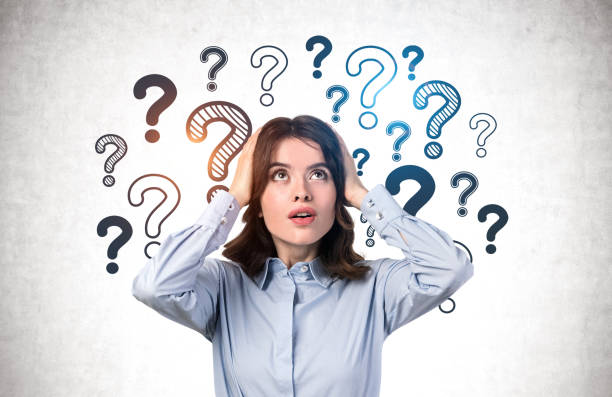 istock Shocked young woman, question marks 1219685739