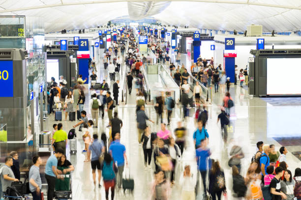istock Blurred people walking in airport 1219687191