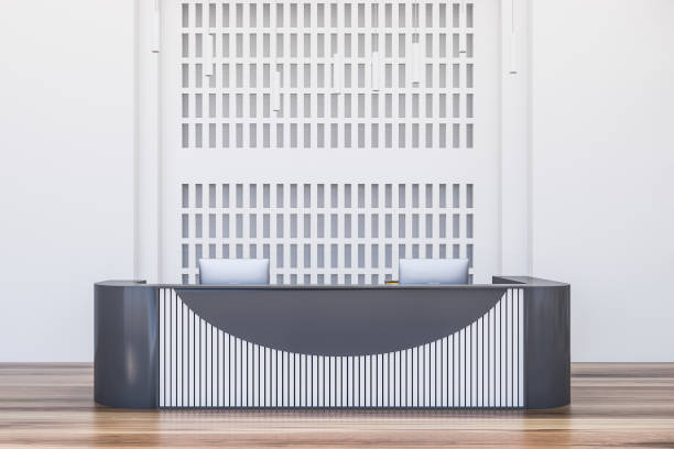 istock Grey and wooden reception desk in office 1219687669