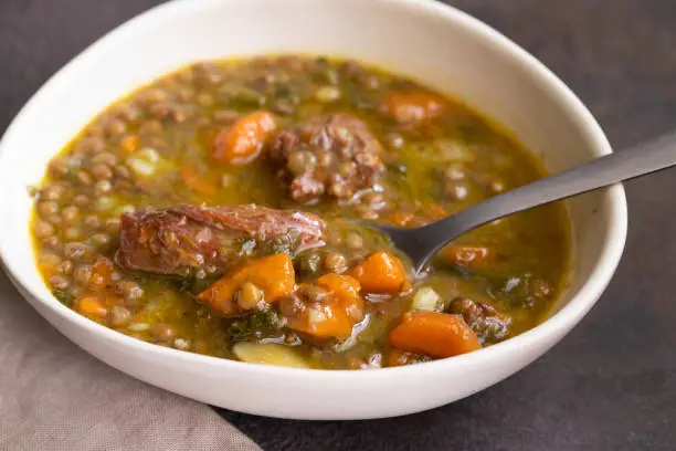 Photo of Lentejas compuestas o stewed lentils delicious Spanish soup , typical dish for cold day.