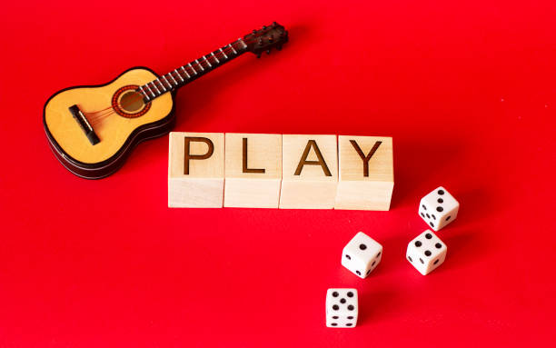 istock dice and guitar on a red background 1219688101