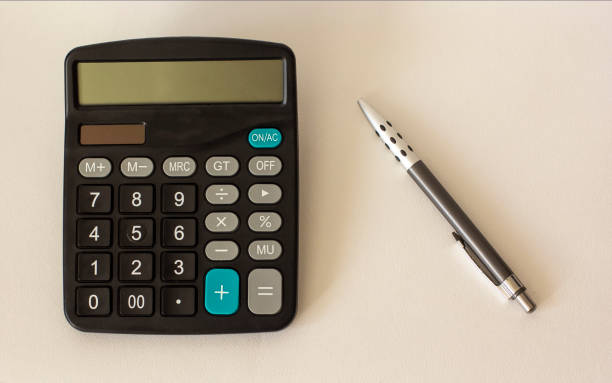 istock on a light background calculator and ballpoint pen 1219688885