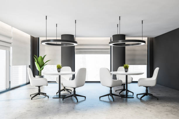 istock Gray office lounge area with white chairs 1219689083