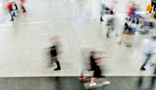 istock Blurred people walking in airport 1219689088