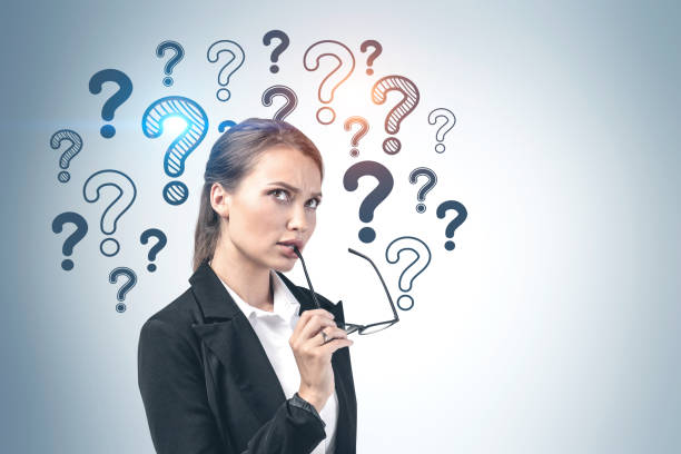 istock Thoughtful young businesswoman, question marks 1219690195