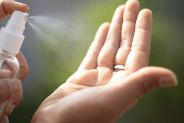 istock hand getting sanitized with hand sanitizer 1219690472