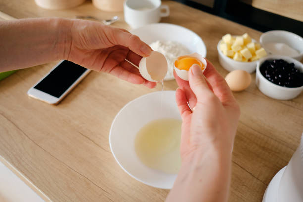 istock Woman breaks chicken eggs in a bowl in the kitchen. 1219691215