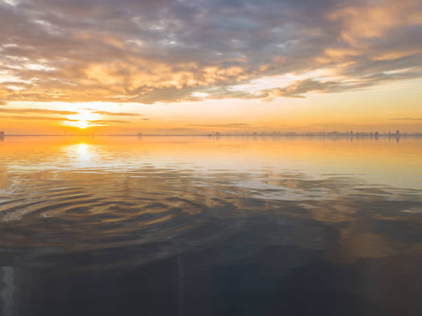 istock Beautiful sunrise over sea with reflection in water. 1219692228
