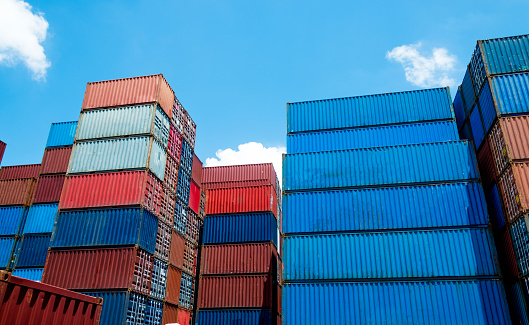 Group of cargo containers under blue sky.
