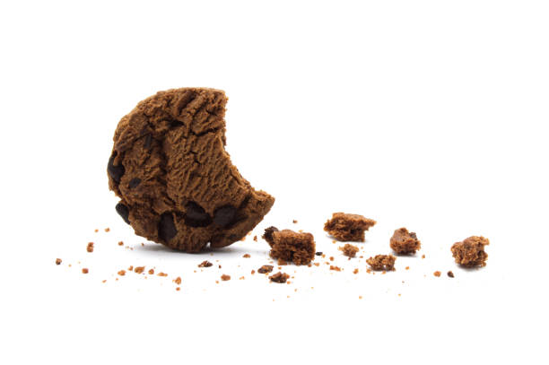 istock Chocolate chip cookies with some broken and crumbs isolated on white background. 1219695440