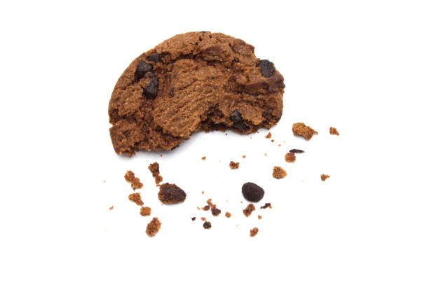 istock Chocolate chip cookies with some broken and crumbs isolated on white background. 1219695587