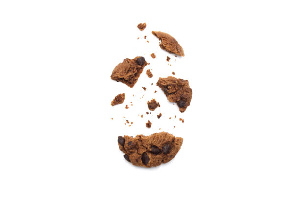 istock Chocolate chip cookies with some broken and crumbs isolated on white background. 1219695604