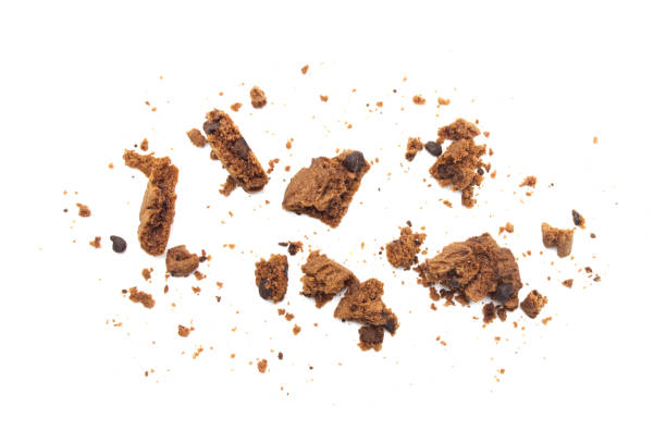 istock Chocolate chip cookies with some broken and crumbs isolated on white background. 1219695611