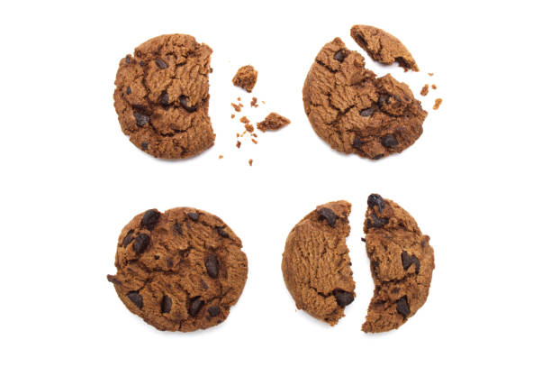 istock Chocolate chip cookies with some broken and crumbs isolated on white background. 1219695632