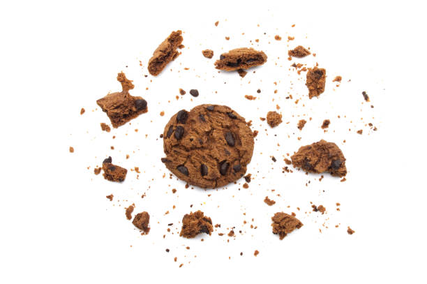 istock Chocolate chip cookies with some broken and crumbs isolated on white background. 1219695633