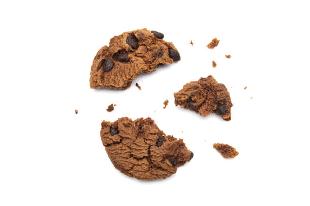 istock Chocolate chip cookies with some broken and crumbs isolated on white background. 1219695647