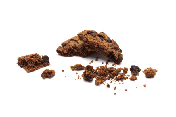istock Chocolate chip cookies with some broken and crumbs isolated on white background. 1219695663