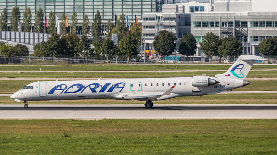 Munich, Germany - September 15, 2019: A Canadair Regional Jet CRJ-900LR from Adria Airways takes off from Munich Airport in the afternoon. The aircraft with the registration S5-AAN has been in use for the Slovenian airline since December 2008. Due to financial problems, Adria Airways filed for bankruptcy in autumn 2019.