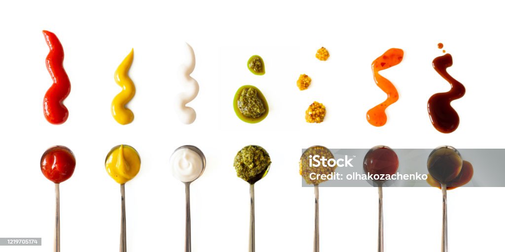 Ketchup, mustard, mayonnaise, basil pesto, sweet chili sauce and teriyaki soy sauce in spoon isolated on white background, top view. Various seasoning and dip border horizontal banner format Barbeque Sauce Stock Photo