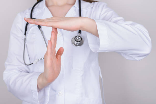 Stop panic concept. Cropped close up photo of nurse making showing timeout symbol isolated over grey background Stop panic concept. Cropped close up photo of nurse making showing timeout symbol isolated over grey background time out signal stock pictures, royalty-free photos & images