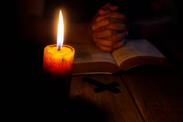 istock Praying woman hands on old holy bible 1219705546