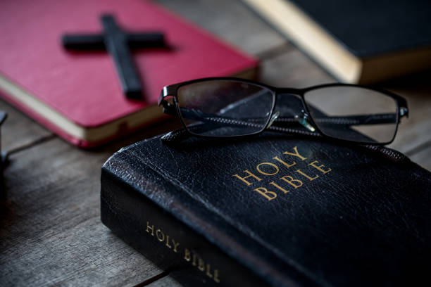 istock Eye glasses on dirty Holy Bible 1219705560