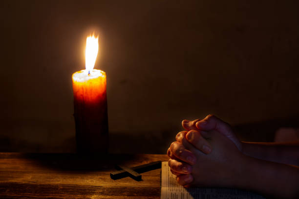 istock Praying woman hands on old holy bible 1219705570