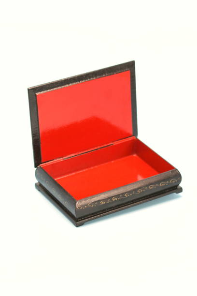 istock Black with gold painted empty lacquered wooden casket stands open. Inside is red 1219705790